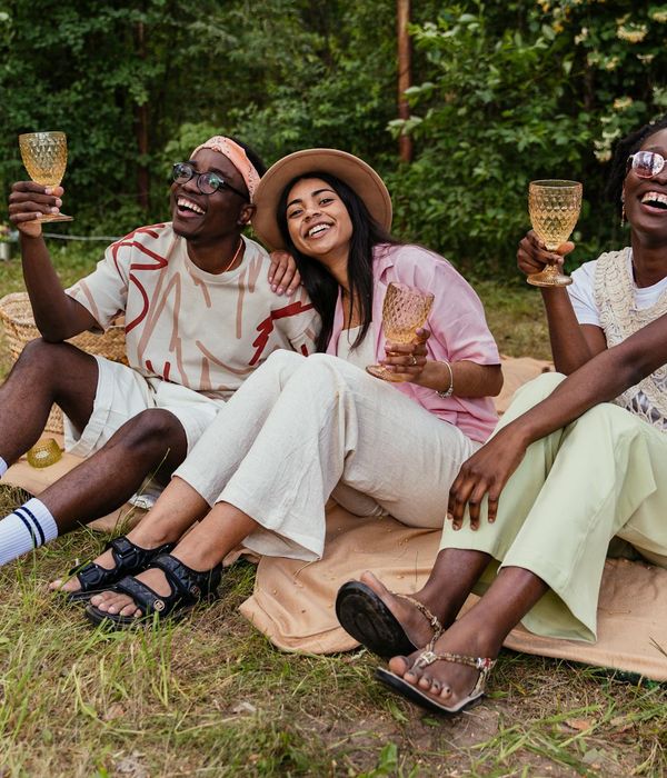 A diverse group of people looking relaxed and happy outdoors.